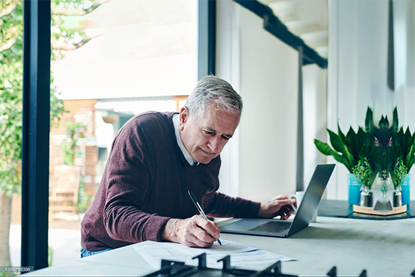 A man is writing a document
